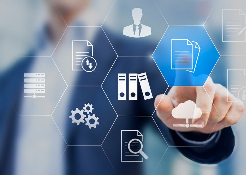 Symbol image; icons (documents, folders, gears, person, etc.) in the foreground, a person points his finger at an icon