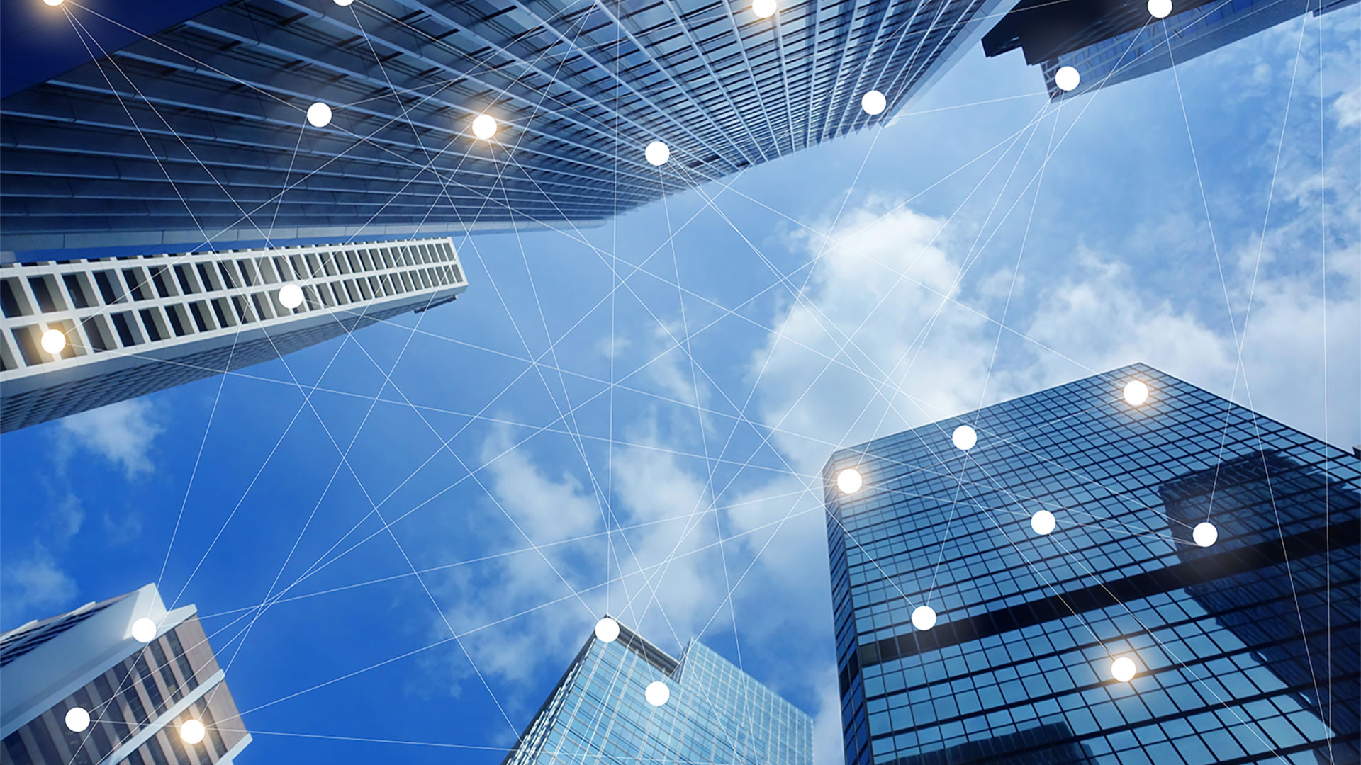 Image: tall office buildings connected via graphic networking lines